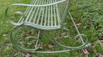 Green metal garden bench rocker